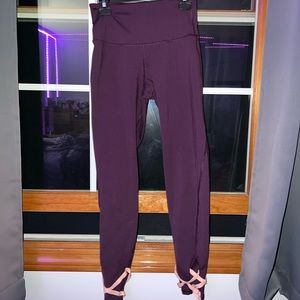 Purple leggings with pink criss cross on the ankles